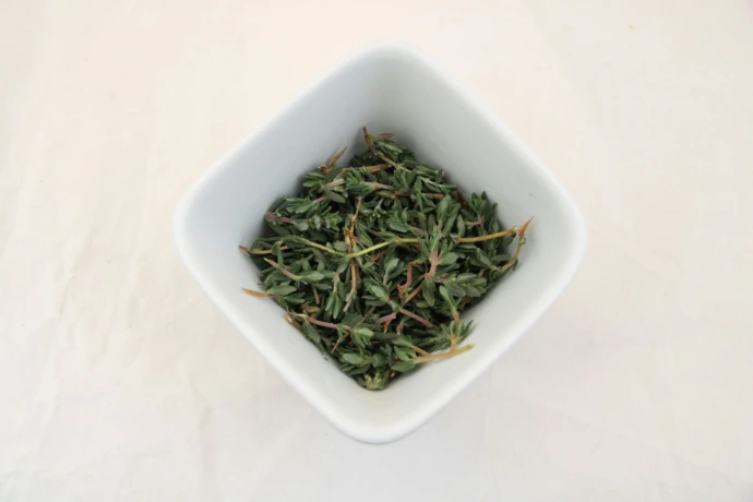 a white bowl filled with green tea on top of a white table